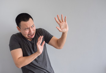 Sad and scared asian man in black  t-shirt.