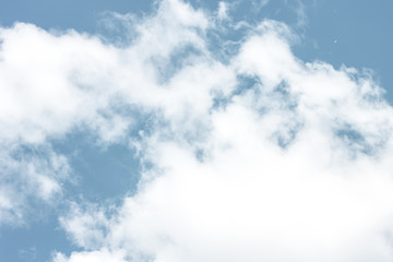 glowing white cloud floating on a rich blue sky