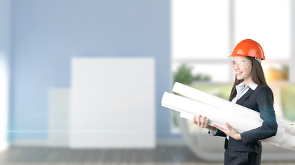 Young beautiful business woman and creative designer standing over blured interior background