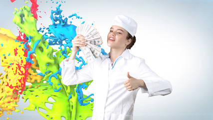 Beautiful medical woman doctor in uniform. Studio painted background. Concept of profitable health care.