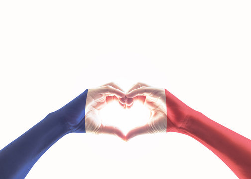 France national flag pattern on people's hands in heart shape on white background (isolated with clipping path)