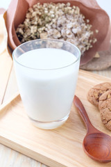 Milk in glass on wooden background