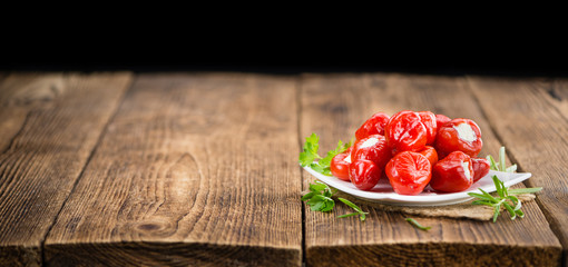 Portion of Red Pepper (stuffed with cheese) on wooden background (selective focus)