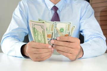 Businessman counting money,US dollar (USD) bills