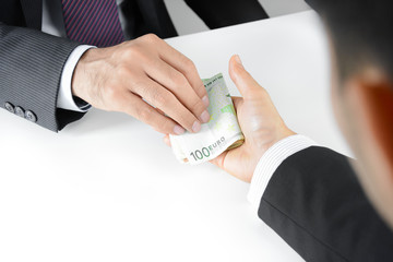 Businessman hands giving & receiving money, Euro currency (EUR) - bribery concept