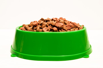 dry food for pets in plastic bowl