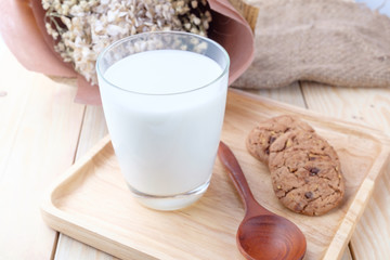 Milk in glass on wooden background