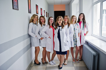 Fototapeta premium Group of gorgeous young female doctors posing in the hospital or clinique.