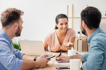 group of young business people having discussion on meeting in office