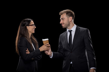 happy colleagues in formal wear drinking coffee, isolated on black
