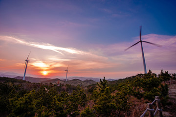 Evening landscape with wind generator
