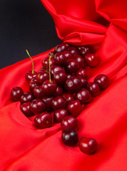 red large cherry on a red and black bright background