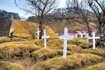 Beautiful old turf church and cemetery dating from 1883 in Hof, Iceland, a popular tourist destination. 