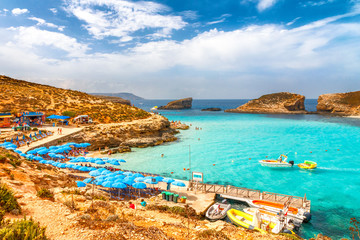 Turquoise lagoon with beach near the Comino island between the islands of Malta and Gozo in the Mediterranean Sea, Europe. - obrazy, fototapety, plakaty