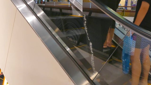 People on moving escalator in public building