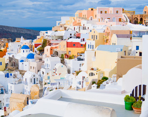 Oia town on Santorini island, Greece. Traditional and famous white and rose  houses at sunny day