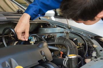 Auto mechanic checking car engine