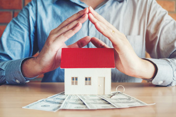 The concept of home ownership and dollars bills