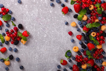 Various fresh summer Berries on the Gray Background.Mix Berries.Food or Healthy diet concept.Super Food.Vegetarian.Top View.Copy space for Text.selective focus.