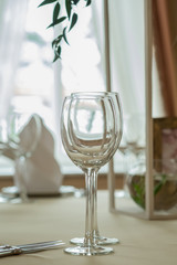 Empty glasses set with napkins in restaurant