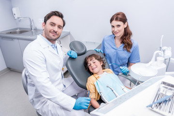Obraz premium dentists preparing little boy for examining teeth at dentist office
