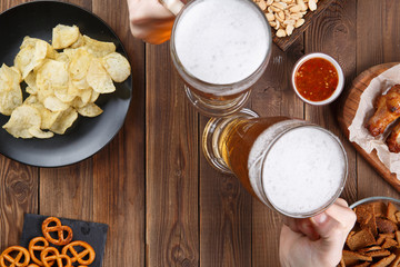 Appetizers and beer on the table for watch the football match.