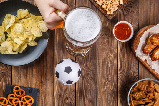 Appetizers and beer on the table for watch the football match.