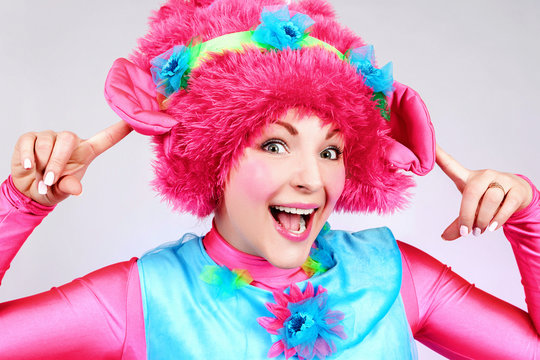Girl clown. Cheerful girl in a clown suit. Leading children's parties.