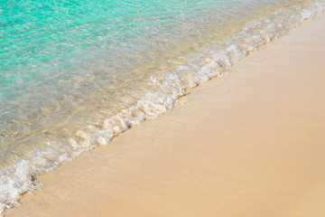 Fototapeta na wymiar Beautiful light blue seashore with sea foam, italian beach, natural marine background