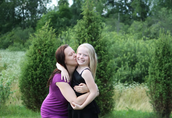 Fototapeta premium Happy adorable little girl and her mother outdoors