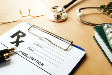 Doctor’s table with medical prescription form. Healthcare concept.