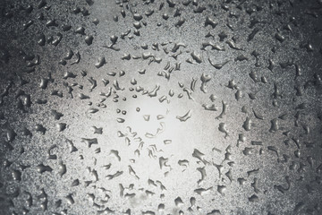 Grey-white background.  Frozen water drops on glass glisten in the sun. frosty pattern . for design. Nature.