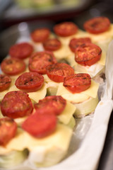 Many plates of appetizers being prepared in commercial kitchen, for an event