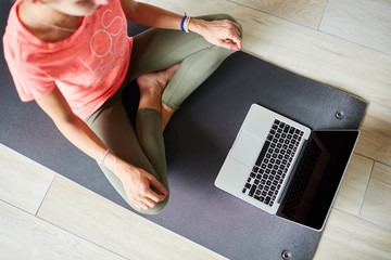 Ragazza fa yoga a casa con pc