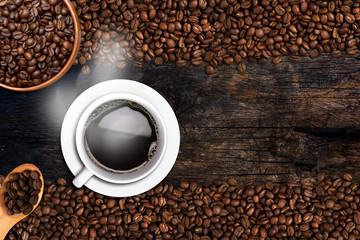 Coffee cup and beans on old wood table. Top view with copy-space for your text