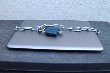 Locked laptop with padlock and chain