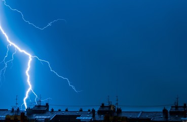Lightning thunderstorm flash over the city
