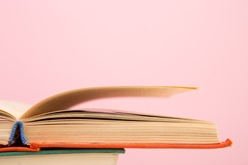 education and wisdom concept - open book on wooden table, color background
