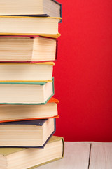 education and wisdom concept - open book on wooden table, color background
