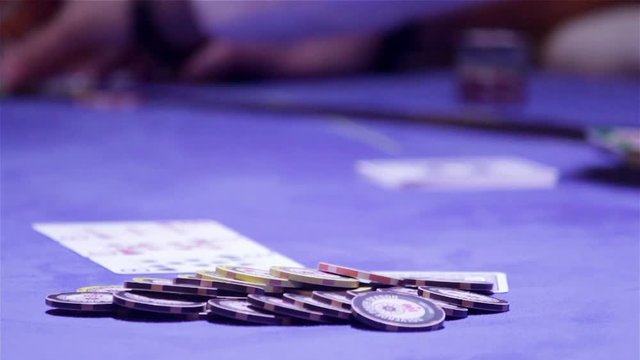 Poker cards game and gambling chips on blue background casino table