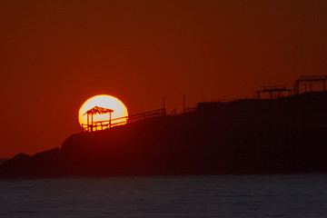 Fototapeta na wymiar GAZEBO ON THE BEACH WITH SUNSET