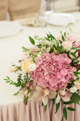 Beautiful decoration on wedding table with roses in bouquet