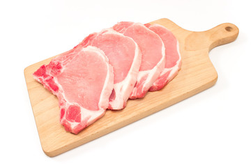 Raw pork chop meat on cutting board isolated on white