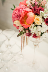 Beautiful decoration on wedding table with roses in bouquet