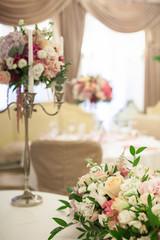 Beautiful decoration on wedding table with roses in bouquet