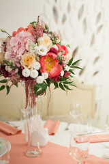 Beautiful decoration on wedding table with roses in bouquet