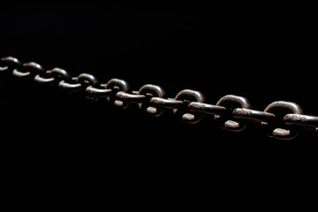Steel chain spotlighted punctual diary lights on black background.