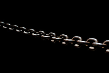 Steel chain spotlighted punctual diary lights on black background.