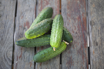 Cucumbers on a old wooden table.
