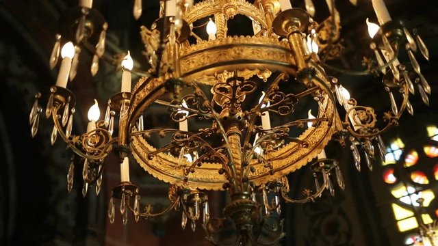 Dolly shot of beautiful luxury chandelier in the church.